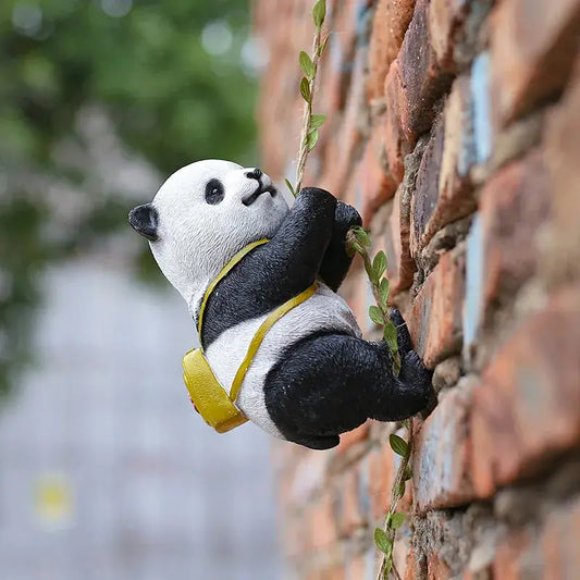 a stuffed panda bear climbing a brick wall