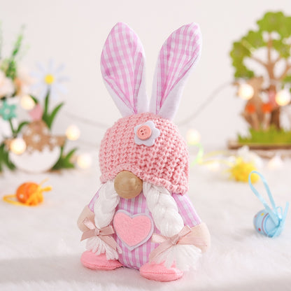 a stuffed rabbit with a pink hat and a pink heart