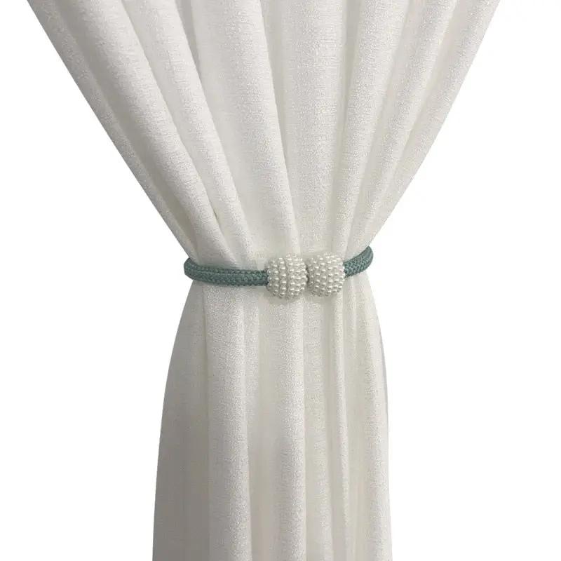 a white curtain with a green belt on it