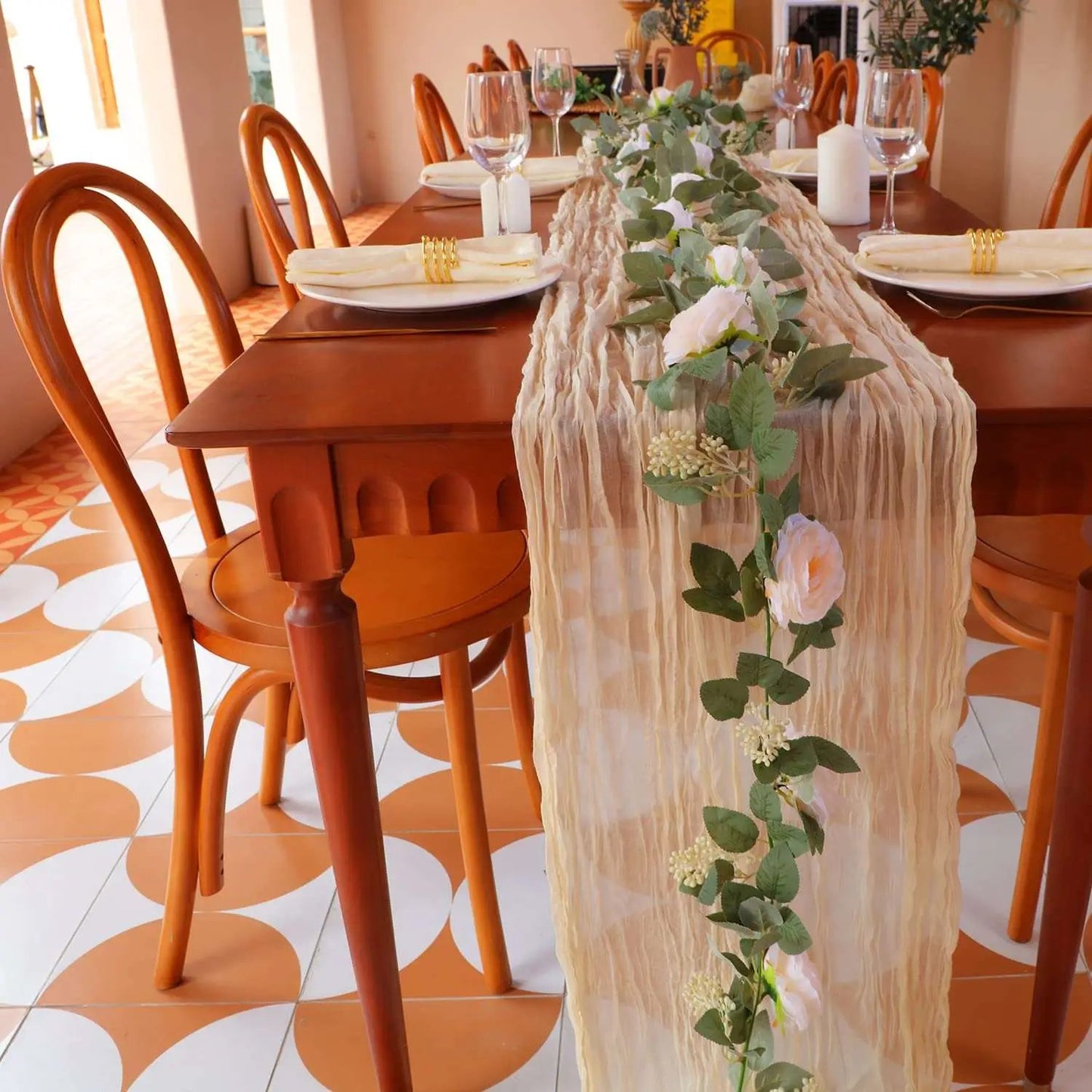 a table with a long table runner with flowers on it