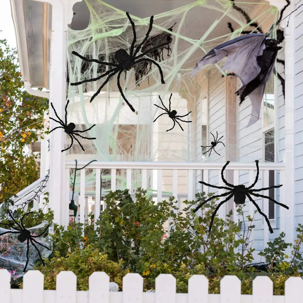 a house decorated for halloween with spider decorations