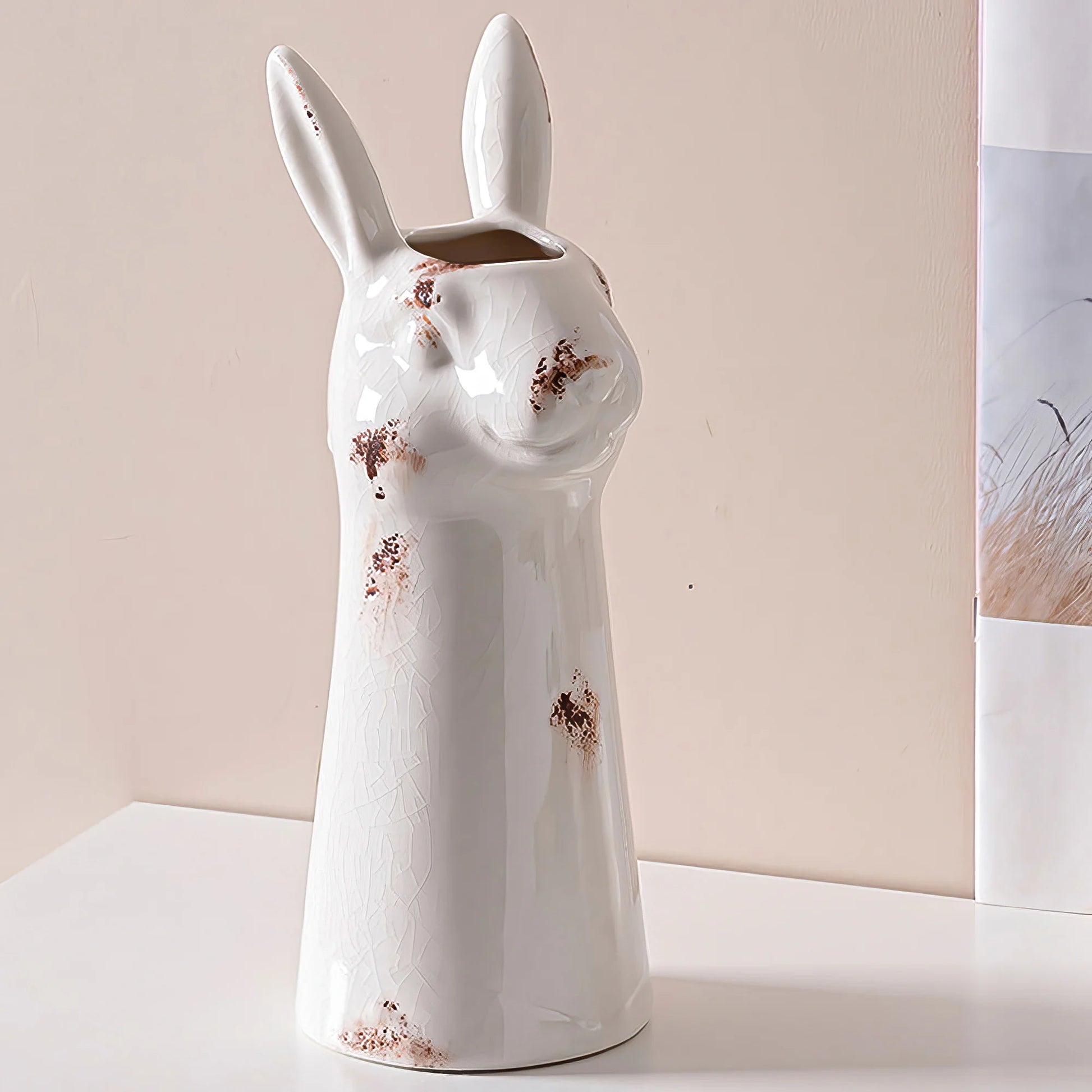 a white ceramic rabbit shaped vase sitting on a table