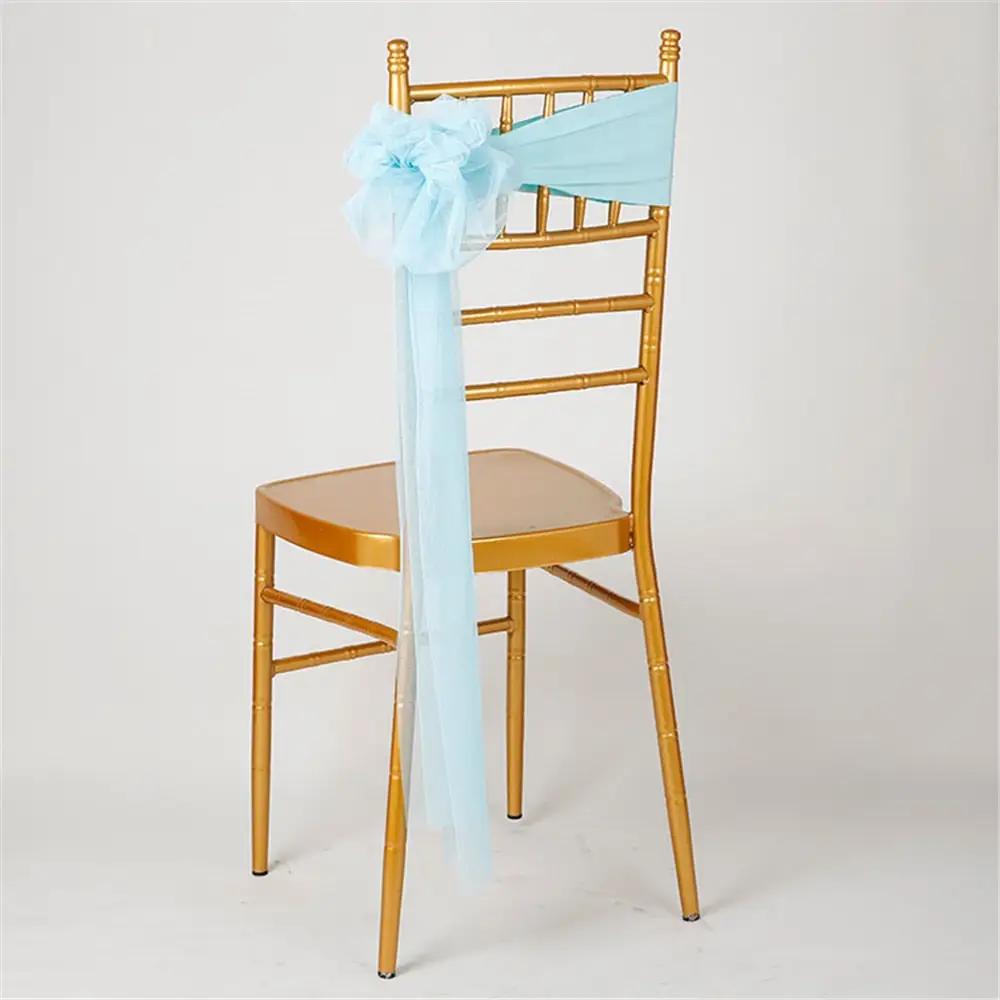 a gold chair with a blue bow on it