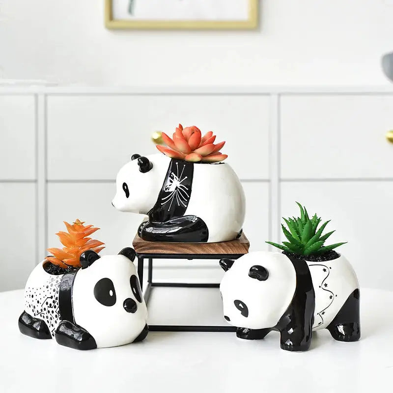 a couple of panda bears sitting on top of a table