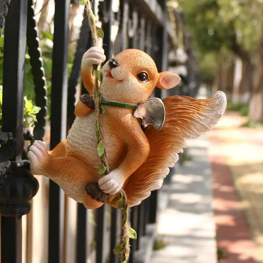 a small figurine of a monkey hanging on a fence