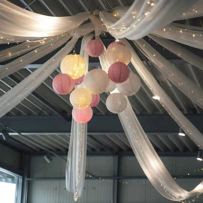 a bunch of paper lanterns hanging from a ceiling
