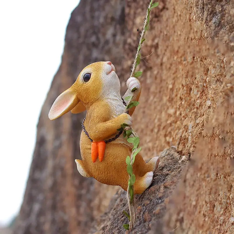 a toy rabbit climbing up the side of a rock