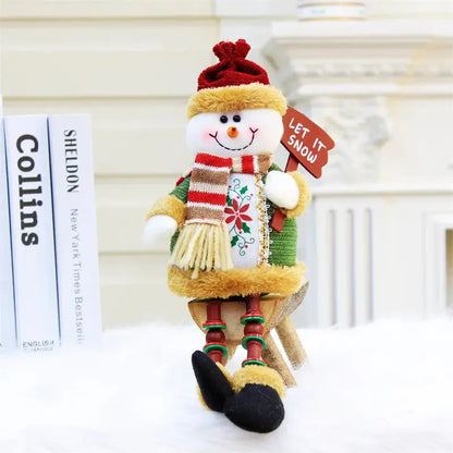 a snowman with a red hat and scarf holding a sign