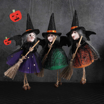 a group of three dolls hanging from strings