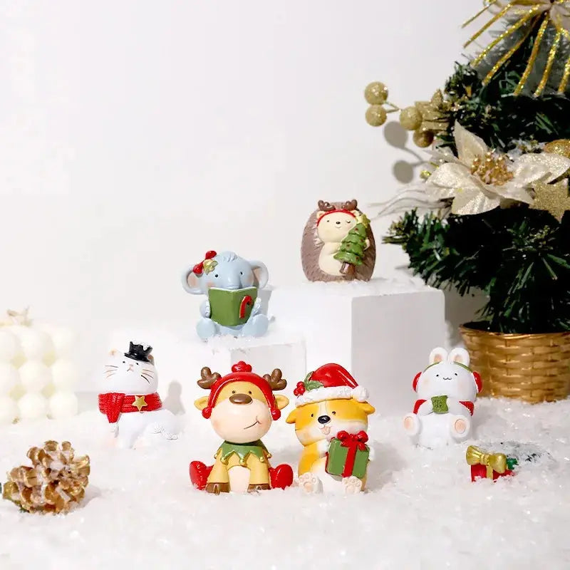 a group of small toy animals sitting on top of a pile of snow