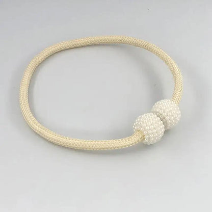 a white beaded bracelet on a white background