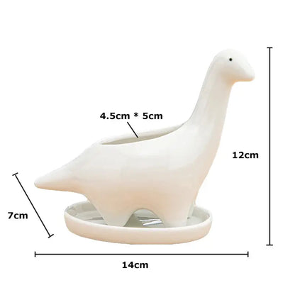 a white ceramic bird on a stand with measurements