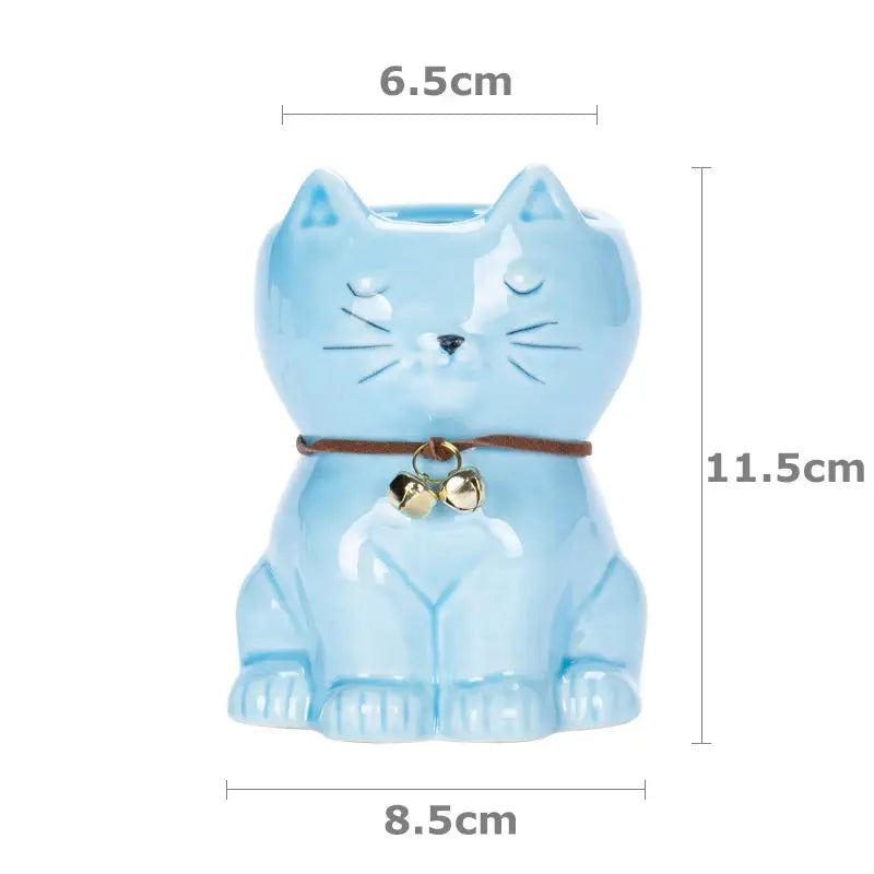 a blue cat figurine with bells on it