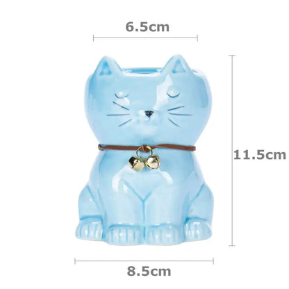 a blue cat figurine with bells on it