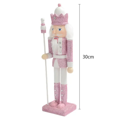 a pink and white nutcracker figurine with a cane