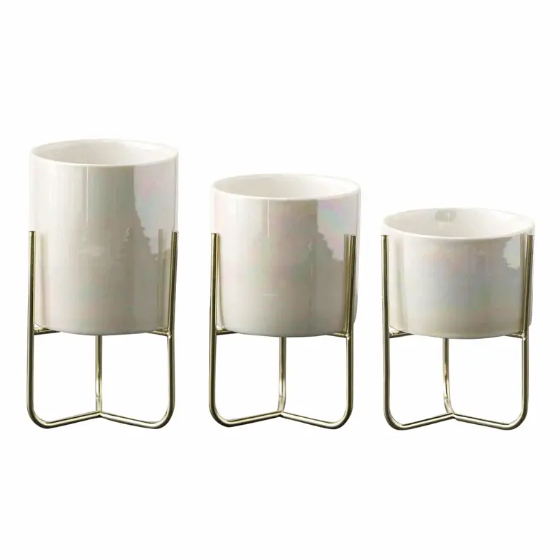 a set of three white vases sitting next to each other