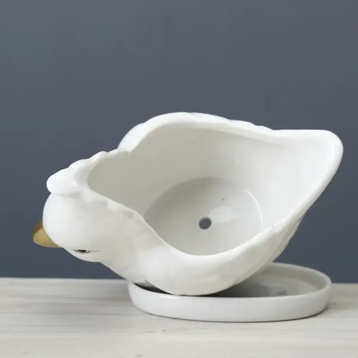 a white ceramic bowl sitting on top of a wooden table