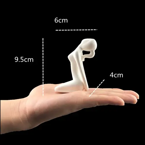 a hand holding a white object with measurements