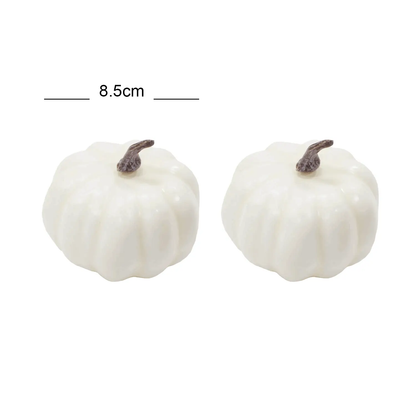 a pair of white pumpkins sitting next to each other