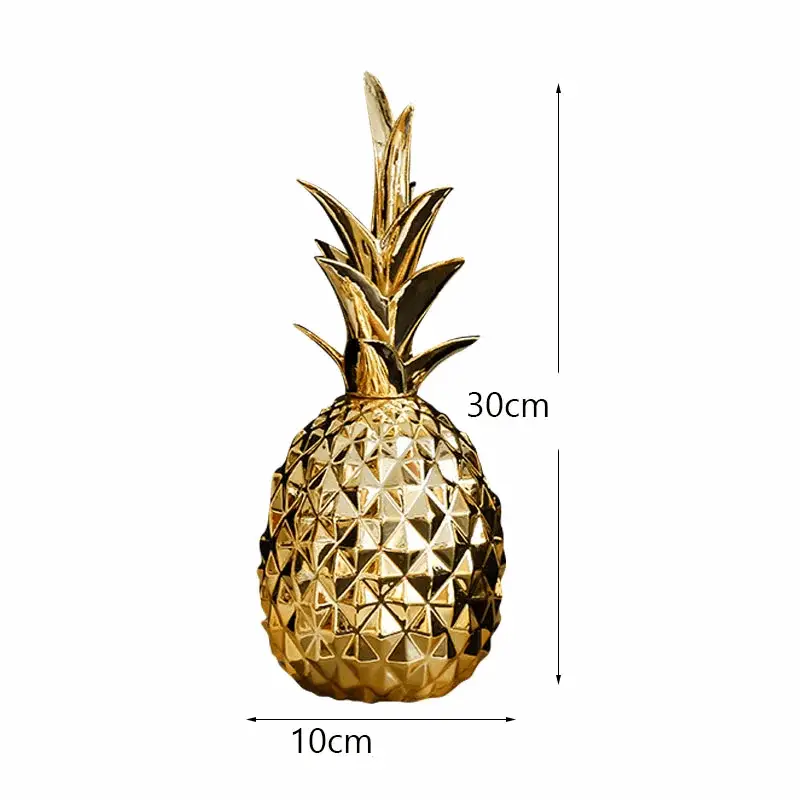 a gold pineapple shaped vase sitting on top of a table