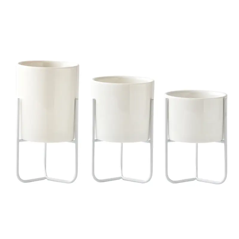 a set of three white vases sitting next to each other