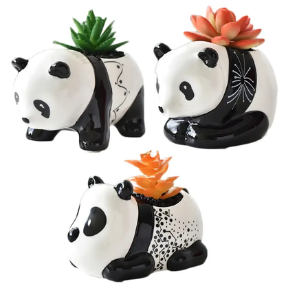 a set of three ceramic panda planters