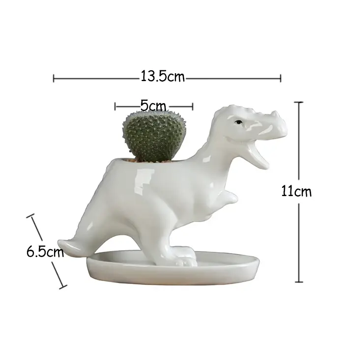 a white ceramic dinosaur planter with a cactus in it