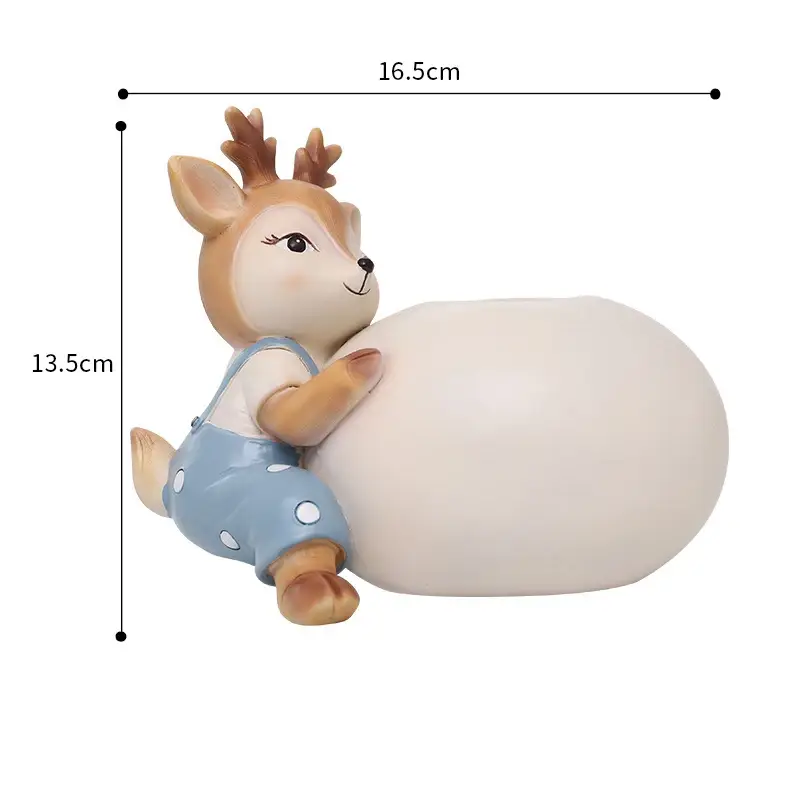 a white and brown deer figurine sitting on top of a white ball