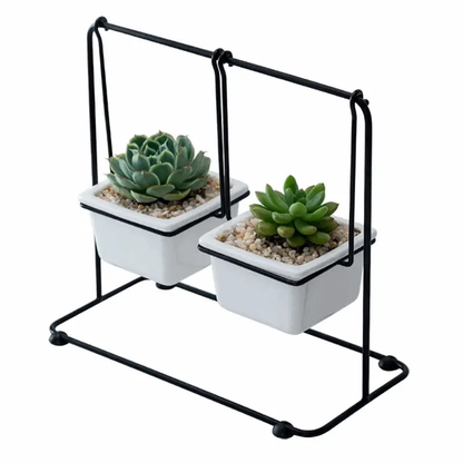 a couple of white planters sitting on top of a metal stand