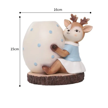 a ceramic figurine of a deer holding a large egg
