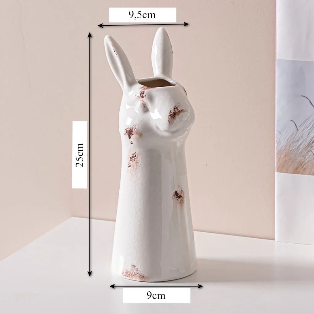 a white ceramic rabbit shaped vase with measurements