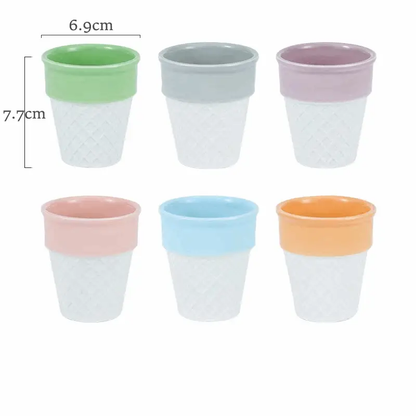 a set of four cups sitting next to each other