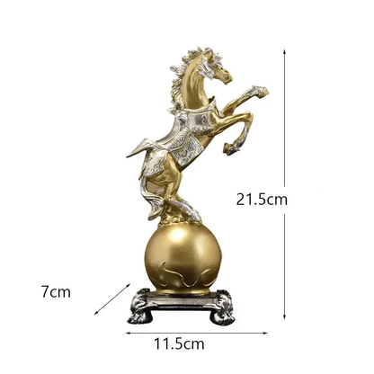 a golden horse statue sitting on top of a ball