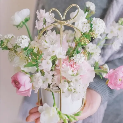 a person holding a vase with flowers in it