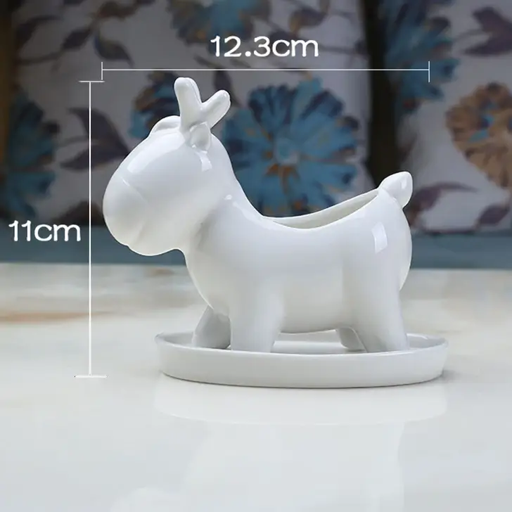 a small white dog figurine on a table