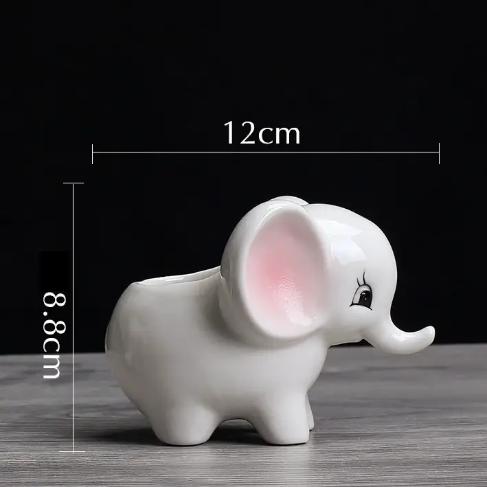 a white elephant figurine sitting on top of a wooden table