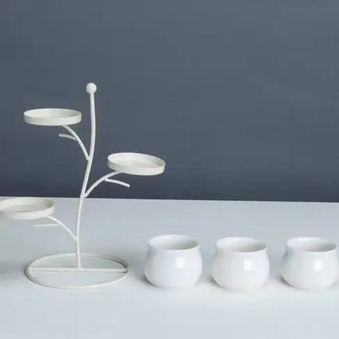 a group of three white cups sitting on top of a table