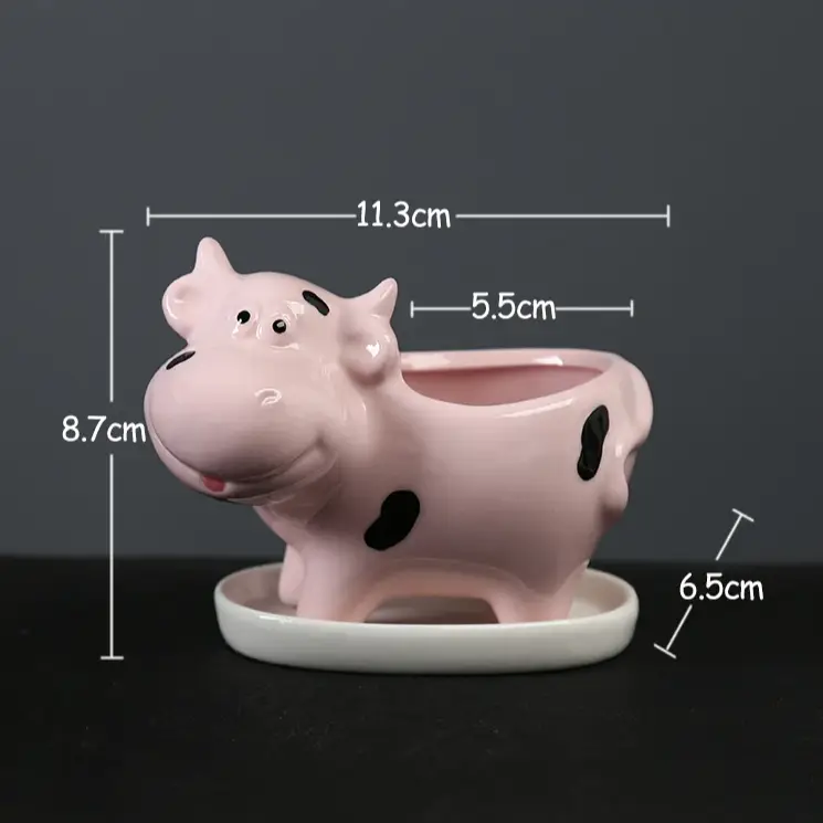 a pink ceramic pig planter sitting on top of a table