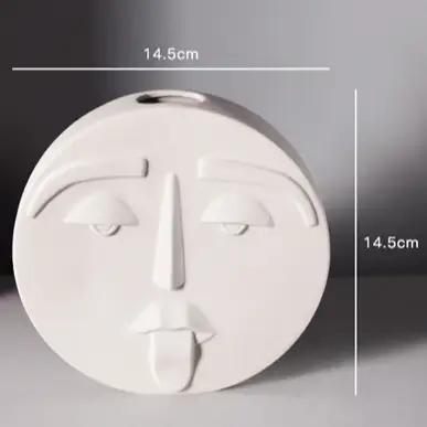 a white ceramic face is shown on a table