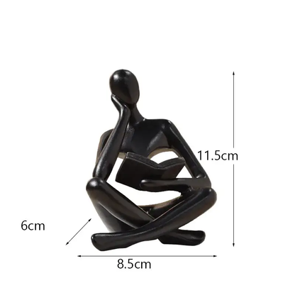 a statue of a person sitting in a yoga position