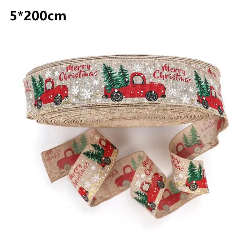 a roll of christmas ribbon with a red truck on it