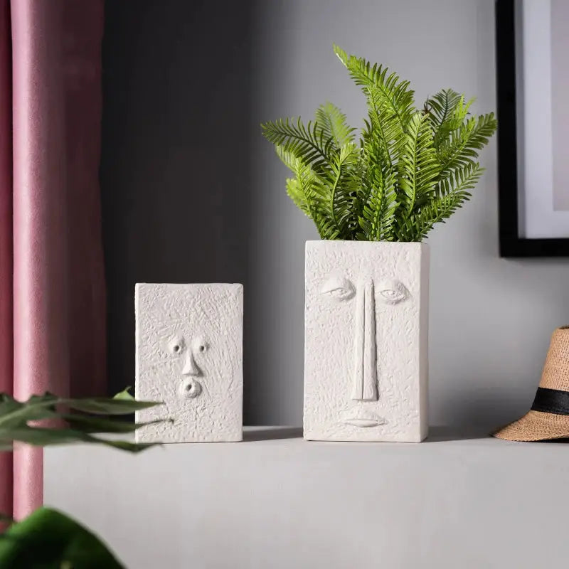 a potted plant sitting on top of a white shelf