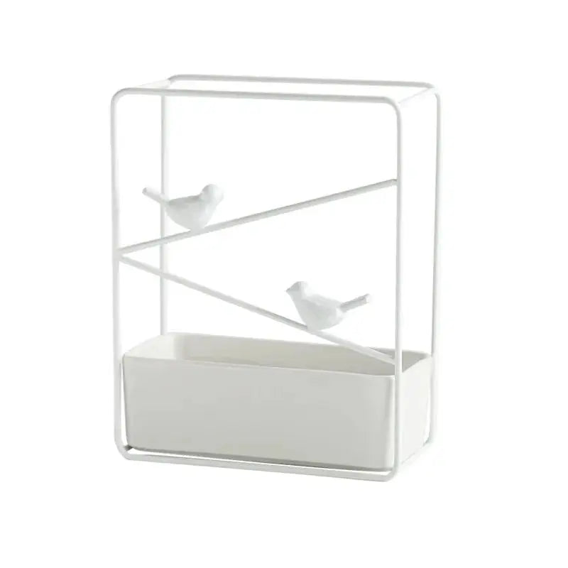 a white shelf with two birds on it