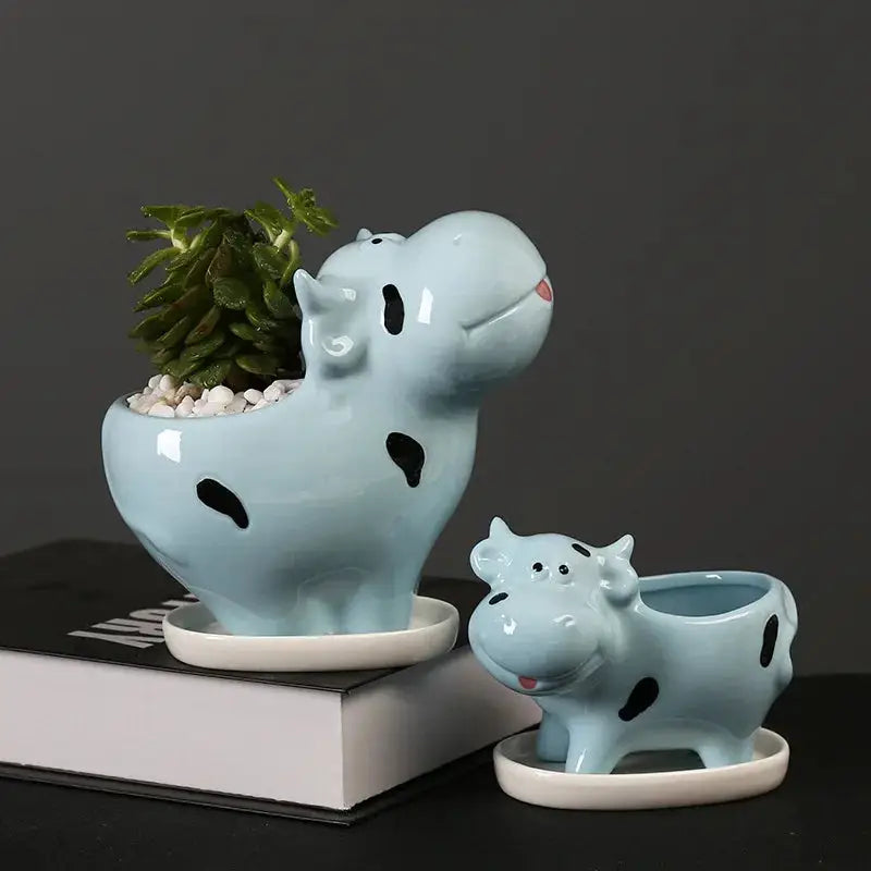 a ceramic planter with a potted plant in it