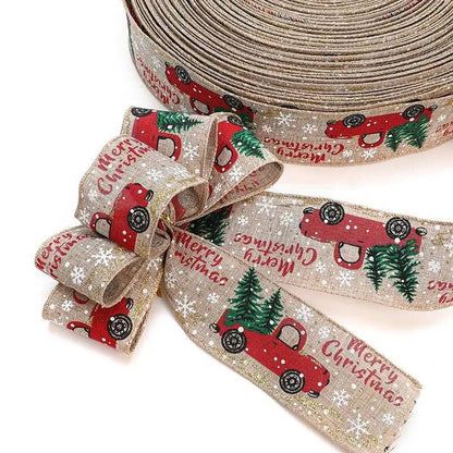 a roll of christmas ribbon with a red truck on it
