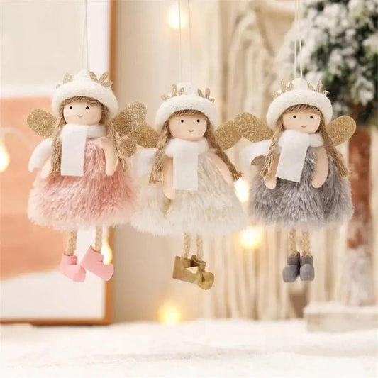three little angel ornaments hanging from a string