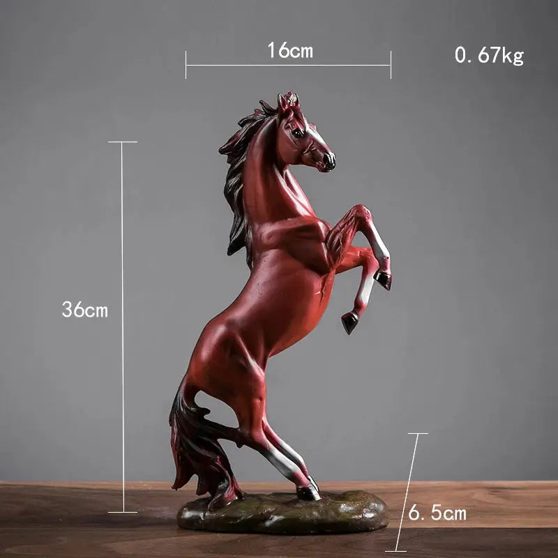 a red horse statue on a wooden table