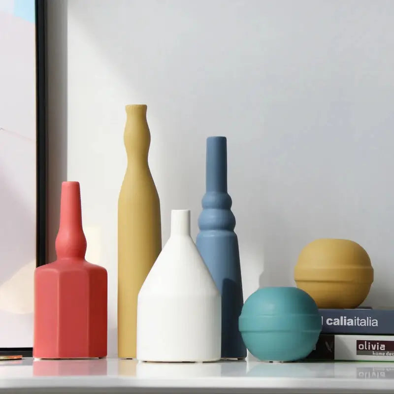 a group of vases sitting on top of a shelf