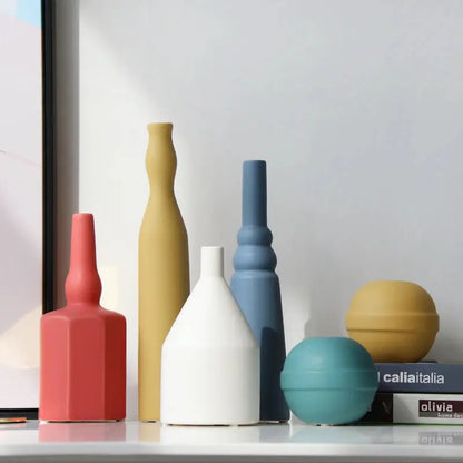 a group of vases sitting on top of a shelf