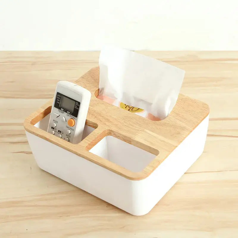 a cell phone and a tissue dispenser on a wooden table